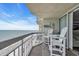 Balcony with chairs overlooking the beach and ocean at 1012 N Waccamaw Dr. # 1107, Murrells Inlet, SC 29576