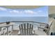 Balcony with Adirondack chairs offers ocean views and a relaxing spot to unwind at 1012 N Waccamaw Dr. # 1107, Murrells Inlet, SC 29576