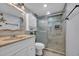 Well-appointed bathroom features a vanity with a faux marble sink and a tiled glass enclosed walk-in shower at 1012 N Waccamaw Dr. # 1107, Murrells Inlet, SC 29576