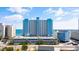 Exterior shows a high rise building at the coast with its parking garage in view on a sunny day at 1012 N Waccamaw Dr. # 1107, Murrells Inlet, SC 29576