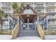 Community entrance with wooden pergola, stairs, and beach access at 1012 N Waccamaw Dr. # 1107, Murrells Inlet, SC 29576