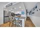 Modern kitchen with white cabinetry, stainless appliances, and counter seating at 1012 N Waccamaw Dr. # 1107, Murrells Inlet, SC 29576