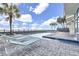 Outdoor swimming pool with lounge chairs and palm trees near the beach at 1012 N Waccamaw Dr. # 1107, Murrells Inlet, SC 29576