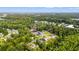 Aerial view showcasing a serene neighborhood surrounded by lush greenery and a tranquil pond at 1051 Academy Dr., Conway, SC 29526