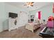 Bright bedroom featuring a ceiling fan, white trim, and a floral comforter at 1051 Academy Dr., Conway, SC 29526