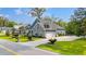 Charming home with lush landscaping and a long driveway leading to a two-car garage at 1051 Academy Dr., Conway, SC 29526