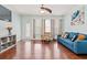 Living room features a blue couch, chair, hardwood floors, and a door to the exterior at 1051 Academy Dr., Conway, SC 29526