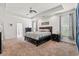 Spacious main bedroom features a tray ceiling, a ceiling fan and neutral decor at 1051 Academy Dr., Conway, SC 29526