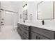 Elegant bathroom showcasing a double vanity with stone countertop, modern fixtures, and a tub-shower combo at 1058 East Isle Of Palms Ave., Myrtle Beach, SC 29579