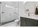 Modern bathroom featuring glass shower, neutral tiles, contemporary fixtures and vanity with marble counters at 1058 East Isle Of Palms Ave., Myrtle Beach, SC 29579