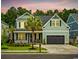 Charming two-story home featuring a manicured lawn, two-car garage and beautiful palm trees at 1058 East Isle Of Palms Ave., Myrtle Beach, SC 29579