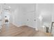 Well-lit hallway with hardwood floors and clean, white walls leading to other rooms in the home at 1058 East Isle Of Palms Ave., Myrtle Beach, SC 29579