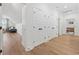 Bright hallway with hardwood floors, white walls, and multiple closet doors offering ample storage space at 1058 East Isle Of Palms Ave., Myrtle Beach, SC 29579