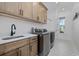 Well-equipped laundry room with modern washer/dryer and ample cabinet space at 1058 East Isle Of Palms Ave., Myrtle Beach, SC 29579