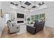 Elegant living room boasts a tray ceiling, fireplace, built-in shelves, and ample seating at 1058 East Isle Of Palms Ave., Myrtle Beach, SC 29579