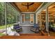 Covered patio with chairs and a swing bed overlooking the backyard at 1058 East Isle Of Palms Ave., Myrtle Beach, SC 29579