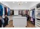 Spacious walk-in closet with custom shelving, hanging racks and central island for optimal clothing and accessory storage at 1058 East Isle Of Palms Ave., Myrtle Beach, SC 29579