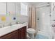 Well-lit bathroom featuring a shower and vanity with dark wood cabinets at 1068 Lizzie Ln., Surfside Beach, SC 29575