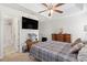 Comfortable bedroom with ceiling fan, large TV, and ensuite bathroom at 1068 Lizzie Ln., Surfside Beach, SC 29575
