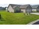 Beautiful single-story home with lush green lawn, pond nearby, and charming front yard landscaping at 1068 Lizzie Ln., Surfside Beach, SC 29575