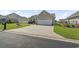 Charming single-story home featuring a well-manicured lawn and a spacious two car attached garage at 1068 Lizzie Ln., Surfside Beach, SC 29575