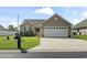Charming single-story home with landscaped front yard and a spacious driveway leading to an attached garage at 1068 Lizzie Ln., Surfside Beach, SC 29575