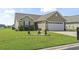 Inviting single-story home with manicured lawn and garden bed leading up to the front door at 1068 Lizzie Ln., Surfside Beach, SC 29575