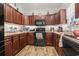Charming kitchen with wood cabinetry, black appliances, and recessed lighting at 1068 Lizzie Ln., Surfside Beach, SC 29575