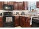 Well-equipped kitchen boasting wooden cabinets, black appliances, and ample countertop space at 1068 Lizzie Ln., Surfside Beach, SC 29575