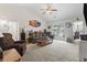 Spacious living room featuring vaulted ceilings, plush carpeting, and sliding glass doors to the patio at 1068 Lizzie Ln., Surfside Beach, SC 29575