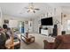Bright living room with plush carpeting, ceiling fan, and sliding doors to the back patio at 1068 Lizzie Ln., Surfside Beach, SC 29575