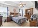 A spacious main bedroom featuring a tray ceiling, ceiling fan, and abundant natural light at 1068 Lizzie Ln., Surfside Beach, SC 29575
