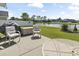Outdoor patio overlooking a serene lake, perfect for relaxing and enjoying the scenery at 1068 Lizzie Ln., Surfside Beach, SC 29575