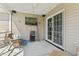 Cozy screened-in patio with wicker furniture and a mounted television at 1068 Lizzie Ln., Surfside Beach, SC 29575