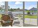 Relaxing screened porch with comfortable wicker chairs and a view of the lake at 1068 Lizzie Ln., Surfside Beach, SC 29575