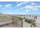Beach access featuring a wooden boardwalk with bench overlooking the ocean and sandy shoreline at 1207 S Ocean Blvd. # 20806, Myrtle Beach, SC 29577