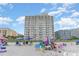 Oceanfront beach with people relaxing under umbrellas and enjoying beach chairs in a coastal setting at 1207 S Ocean Blvd. # 20806, Myrtle Beach, SC 29577