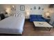 Cozy bedroom with queen bed, blue loveseat, side tables, and stylish decor at 1207 S Ocean Blvd. # 20806, Myrtle Beach, SC 29577