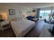Bright bedroom with queen bed, sitting area, desk and beach views at 1207 S Ocean Blvd. # 20806, Myrtle Beach, SC 29577