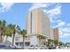 Exterior building with balcony views and palm tree landscaping near parking area at 1207 S Ocean Blvd. # 20806, Myrtle Beach, SC 29577