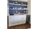 Modern kitchenette with blue tile backsplash, white cabinets, and beverage cooler at 1207 S Ocean Blvd. # 20806, Myrtle Beach, SC 29577