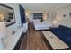 Bright living room featuring a queen bed, blue accents, a seating area, and kitchenette at 1207 S Ocean Blvd. # 20806, Myrtle Beach, SC 29577