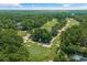 Stunning aerial view of a lush golf course surrounded by mature trees and picturesque landscapes at 124 Wicklow Way, Pawleys Island, SC 29585