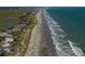 Breathtaking aerial view of a scenic beach with ocean waves, showcasing the beauty of coastal living at 124 Wicklow Way, Pawleys Island, SC 29585