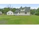 View of the home's rear exterior, featuring a well-kept yard and detached outbuilding at 124 Wicklow Way, Pawleys Island, SC 29585