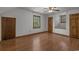 Spacious bedroom featuring hardwood floors, neutral walls, and natural light from the windows at 124 Wicklow Way, Pawleys Island, SC 29585