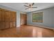 Bedroom with hardwood floors, ceiling fan and wood-toned closet doors at 124 Wicklow Way, Pawleys Island, SC 29585