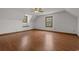Large bedroom featuring hardwood floors and natural light from two windows at 124 Wicklow Way, Pawleys Island, SC 29585