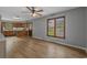 Open dining area with hardwood floors, a ceiling fan, and natural light, seamlessly connecting to the kitchen at 124 Wicklow Way, Pawleys Island, SC 29585
