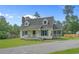 Charming home featuring a cozy front porch, well-maintained yard, and classic architectural details at 124 Wicklow Way, Pawleys Island, SC 29585